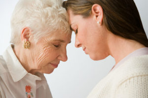 Mother and daughter look intently while considering caregiver choices